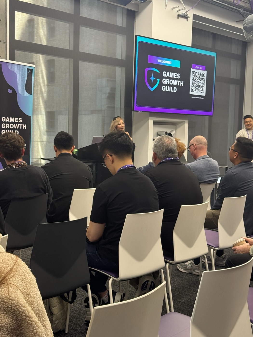 A speaker addresses the audience at a Games Growth Guild meetup